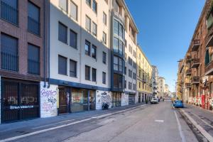 an empty street in a city with buildings at Italianflat - Il Giardino del naviglio Terrace in Milan