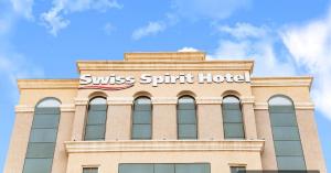 a building with the words swiss spirit hotel on it at Swiss Spirit Hotel & Suites Dammam Corniche in Dammam