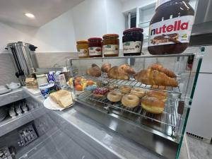 a display case in a kitchen with many different types of pastries at La Bella Guesthouse in St. Julianʼs