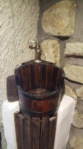 a wooden toilet sitting on top of a stone wall at Riolit Barlangszállás Szomolya in Szomolya