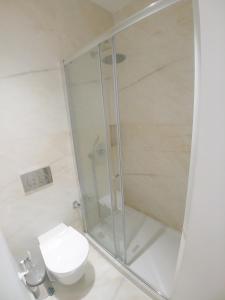a shower stall in a bathroom with a toilet at Be Local - 2 bedrooms in front of the Fado Museum in Alfama in Lisbon