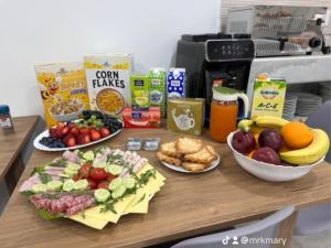 a table topped with plates of food and fruit at La Bella Guesthouse in St. Julianʼs