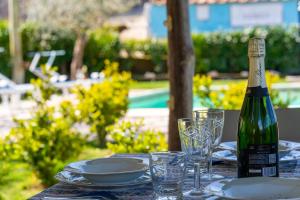 een fles wijn op een tafel met glazen bij Il Tiglio-Holiday Home in Massa Lubrense