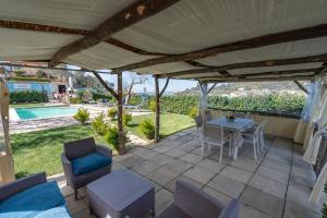 een patio met een tafel en stoelen en uitzicht bij Il Tiglio-Holiday Home in Massa Lubrense