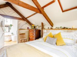 a bedroom with a large bed with yellow pillows at 1 Bed in Great Torrington 00782 in Sheepwash