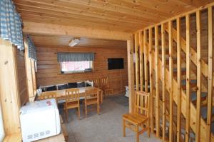 a dining room with a table and chairs in a cabin at Stärhusvägen 6B in Sälen