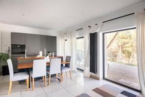 a kitchen and dining room with a table and chairs at Entre Aix et Marseille in Rognac