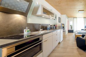 a kitchen with a sink and a stove top oven at Erfblick-Apartments in Eichenbühl
