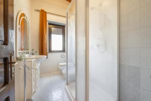 uma casa de banho com um WC, um lavatório e um chuveiro em Villa bifamiliare con giardino em Teulada