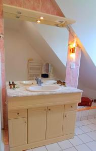 a bathroom with a sink in an attic at Jolie maison à 800m de la plage in Hermanville-sur-Mer +21 photos