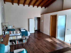 a living room with a bed and a book shelf at Apartamento con terraza Blanes playa, Costa Brava in Blanes +36 photos