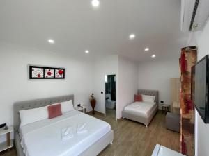 מיטה או מיטות בחדר ב-Vila Ari