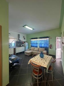 a living room with a table and a couch at A Escapadinha in Ribeira da Janela