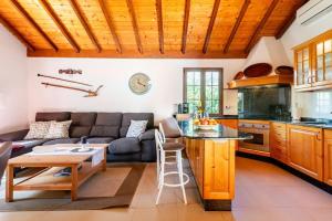 a kitchen and living room with a couch and a table at Casa Simón in Fátaga