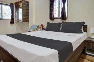 Кровать или кровати в номере OYO Hotel Sai Galaxy