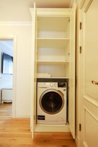 a laundry room with a washer and dryer at Boutique Apartments Kempes in Liepāja