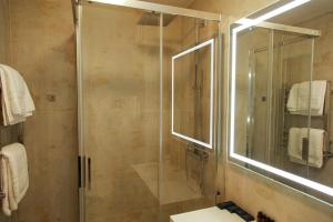 a bathroom with a shower with a glass door at Boutique Apartments Kempes in Liepāja