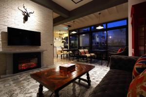 a living room with a fireplace and a table at 1999 B&B in Hualien City