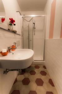 a bathroom with a white sink and a shower at B&b Regina in San Miniato