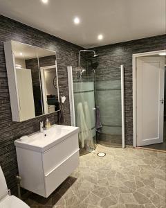 a bathroom with a sink and a shower at Guesthouse Erlandseröd in Strömstad +19 photos