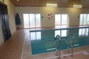 a large swimming pool in a room with at Cornstore in Saint Florence