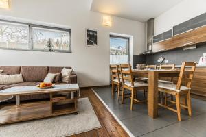 a kitchen and living room with a table and chairs at Mountain Villas Polana in Starý Smokovec +49 photos