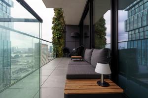 a balcony with a couch and a table on a building at Skyline Blick Frankfurt - Nahe Messe in Frankfurt