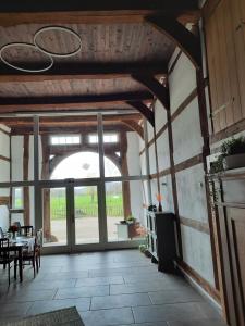 a living room with a table and a large window at Ferienhof Klemme in Rinteln