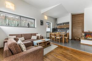 a living room with a couch and a table at Mountain Villas Polana in Vysoke Tatry - Novy Smokovec