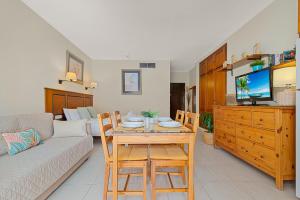 a living room with a table and a couch at Solana Fuengirola 40 in Fuengirola