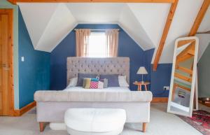 a bedroom with a bed with a blue wall at Laimhrig in Torrin