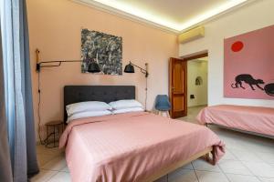 1 dormitorio con 1 cama con edredón rosa en Redseven Rome Apartments, en Roma