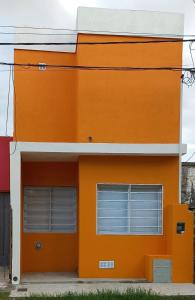 an orange building with two garage doors at Casa - Departamento - Loft in Concepción del Uruguay