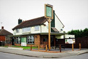 a building with a sign in front of it at Perfect Contractor Stay House I Sleeps 7 People I 20 Percent Off xx LIMITED OFFER xx in Borehamwood