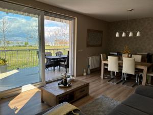 a living room with a large sliding glass door at Panorama Apartman Zamardi in Zamárdi