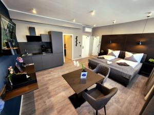a living room with a bed and a dining room at Liro Hotel Oberhausen in Oberhausen