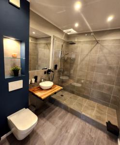 a bathroom with a shower and a sink and a toilet at Liro Hotel Oberhausen in Oberhausen