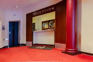 a red pole in front of a store with a reception at Hotel Graf Moltke Hamburg in Hamburg