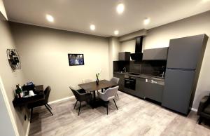 a kitchen and dining room with a table and chairs at Liro Hotel Oberhausen in Oberhausen