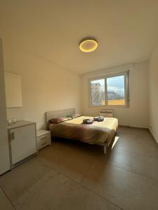 a bedroom with a bed and a window at *Veranda's rooms* - Free parking in central Lugano in Lugano