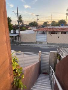 a view of a street from a building with a gate at New House Temporada in João Pessoa