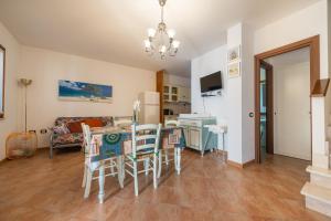 a kitchen and dining room with a table and chairs at Casa vacanze sole e mare in Porto Pino