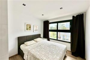 a bedroom with a bed and a large window at White Lion Apartment N2 Kallithea in Kallithea Halkidikis +9 photos