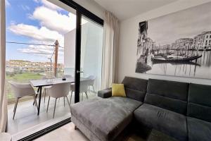 a living room with a couch and a table at White Lion Apartment N2 Kallithea in Kallithea Halkidikis