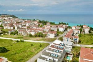 an aerial view of a town with houses and the ocean at White Lion Apartment N2 Kallithea in Kallithea Halkidikis