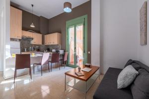 a living room with a couch and a table at URBAN Center Apartments in Tarragona