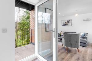 a sliding glass door leading to a balcony at Smethwick Deluxe 2 Bedroom Aparetment - Secure Parking - Balcony - Rated Exceptional - 9MC in Birmingham