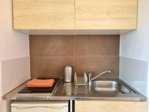 a kitchen with a sink and a counter top at Joli studio lumineux centre avec parking securise dans quartier recherche in Aix-en-Provence
