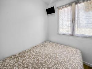 a small bedroom with a bed and a window at Retraite Bucolique à Leyment in Leyment