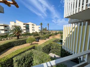 a view of a garden from a balcony of a building at Studio cabine avec piscine, parking sécurisé et accès direct plage à Saint-Cyprien - FR-1-753-15 in Saint-Cyprien